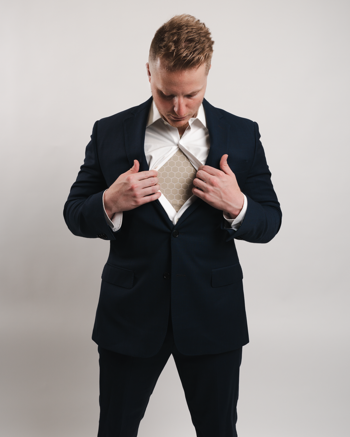 man opening suit showing Compression Shirt underneath 