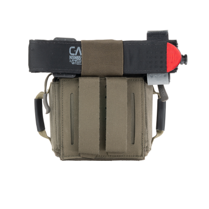 The RTS Tactical Rapid Deploy IFAK Mini with a tourniquet attached to the top.