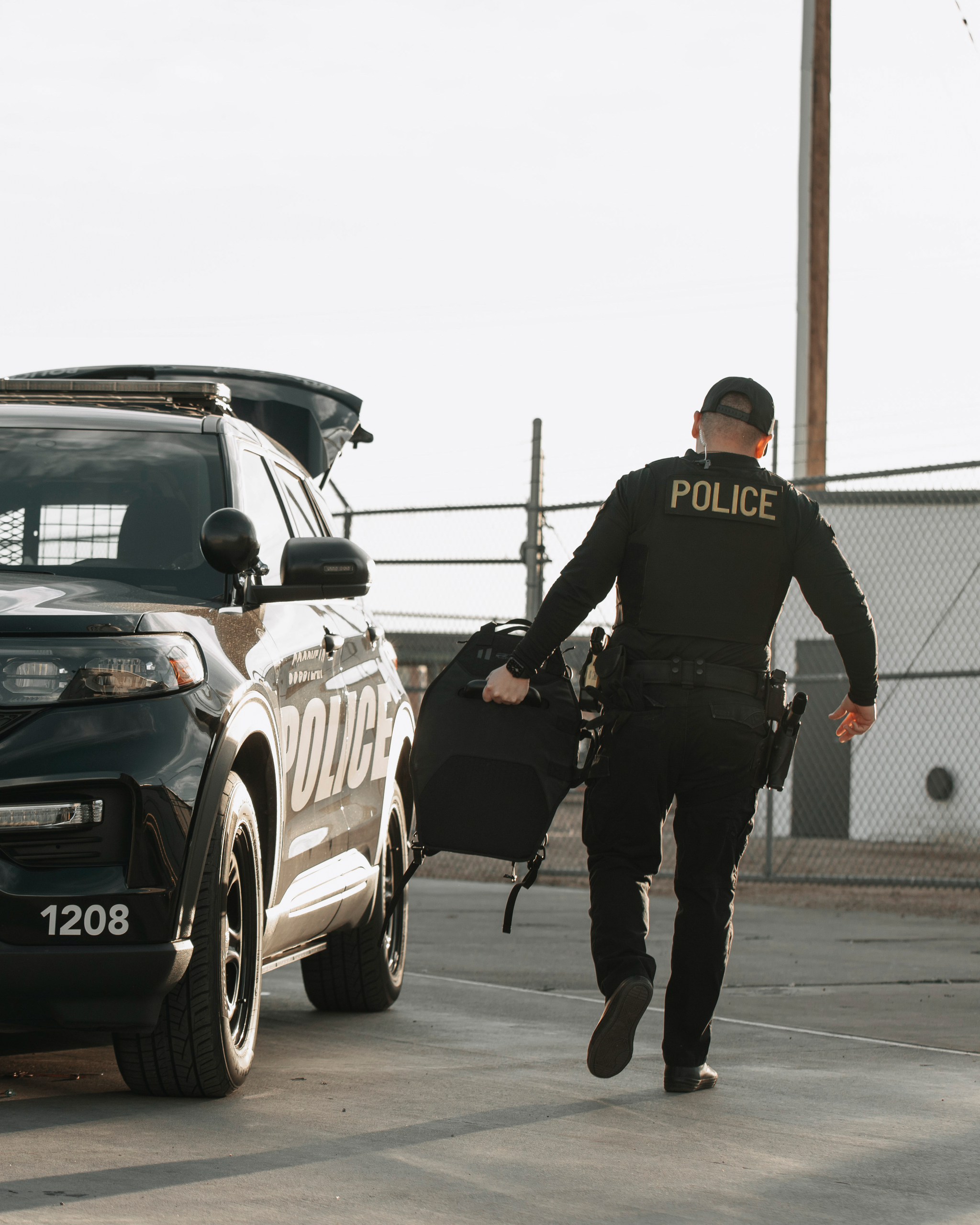 A law officer carrying the Special Threats mini shield to place it in his vehicle.