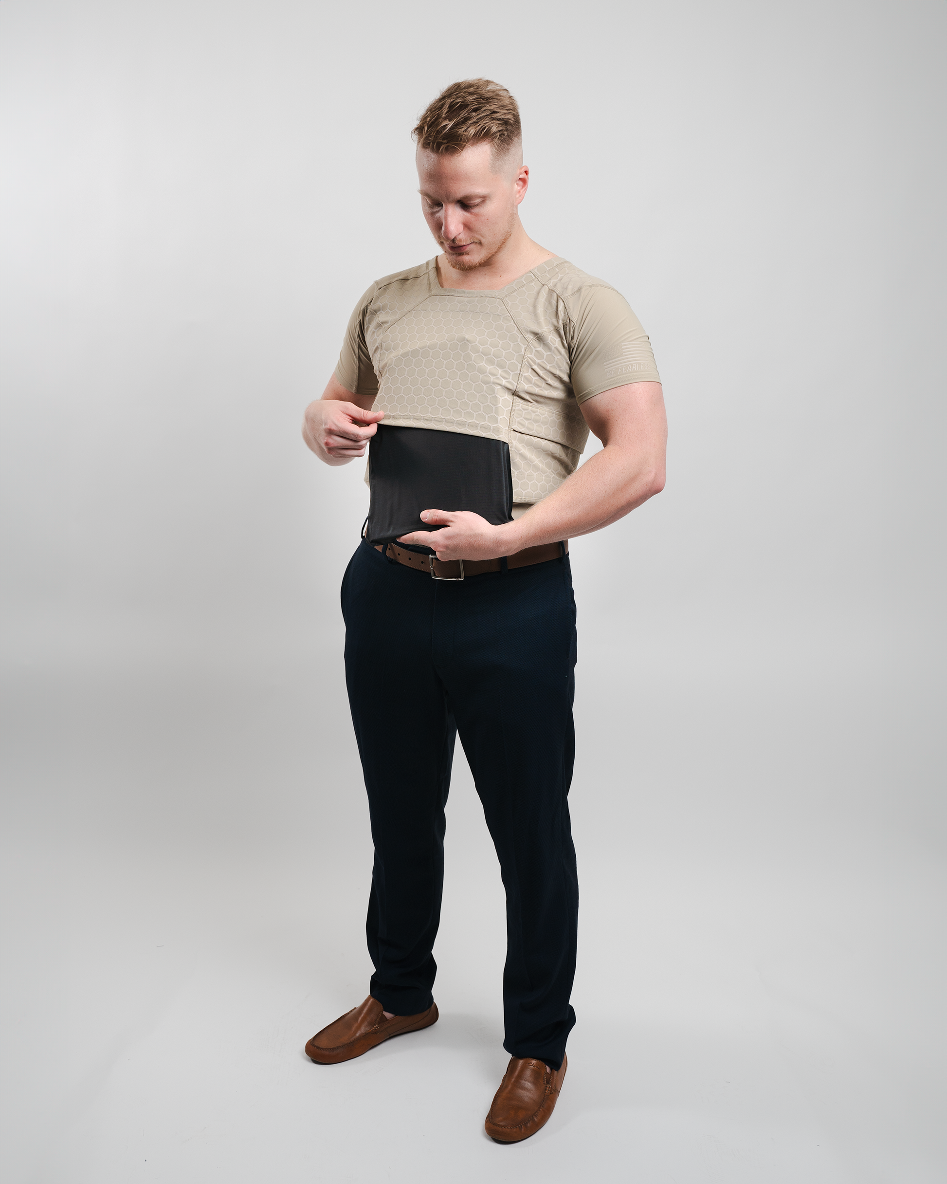 Man wearing body armor Compression Shirt placing ballistic panel in shirt pocket 